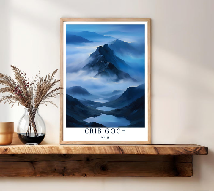 A scenic display of a retro Crib Goch misty mountain travel print, showing an example of our canvas, unframed, and framed layout formats. The poster artwork uses cold, deep seasonal tones to portray a legendary and inspiring outdoor trail view.