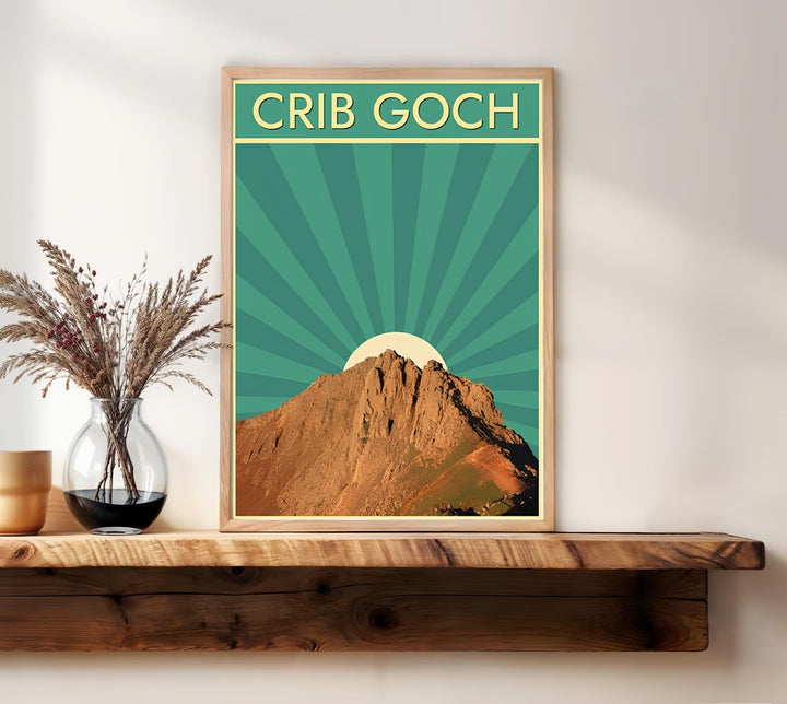 High-quality travel poster artwork displaying a Crib Goch Snowdonia landscape illustration, purchasable as canvas wall art, an unframed print, or a framed art piece. The stylized Wales mountain print captures the dramatic texture of the rocky peaks contrasted with a geometric retro green sunburst pattern.