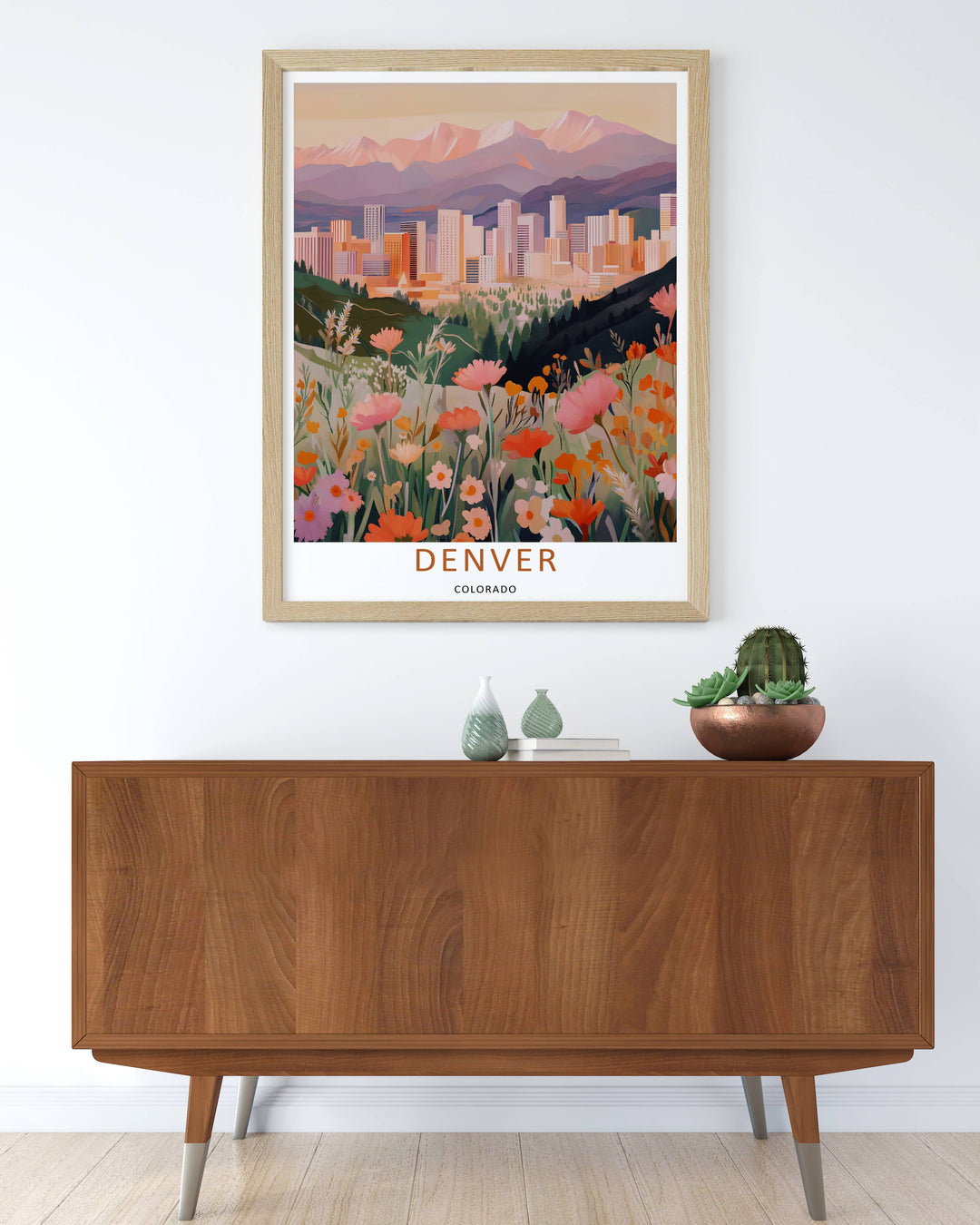 Grand Rocky Mountain peaks and a distant metropolitan core resting under a warm peach sky in a clean vector travel design. This beautiful wall art makes an excellent housewarming gift as a canvas print, framed poster, or simple print.