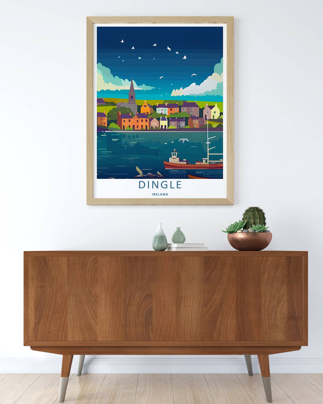 Modern wall art featuring a retro graphic layout of the classic Dingle Ireland harbor view, which can be ordered as a stretched canvas, an unframed poster, or a framed print. The landscape art details a fishing trawler floating near a village.