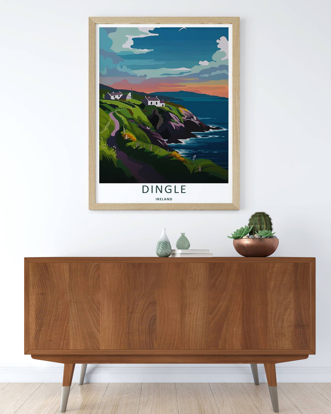 Modern wall art featuring a retro graphic layout of the classic Dingle Ireland twilight view, which can be ordered as a stretched canvas, an unframed poster, or a framed print. The landscape art details warm orange clouds over the ocean.