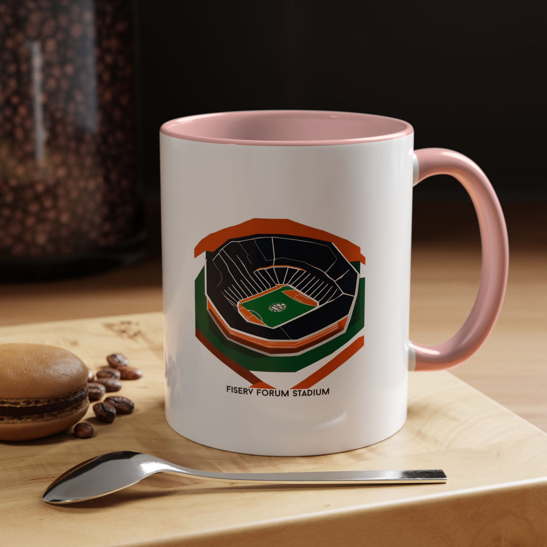 A pink mug featuring the architectural outline of Fiserv Forum, making it a standout piece for Milwaukee Bucks fans who enjoy stylish and expressive merchandise. Great for sipping hot beverages, using at work, or gifting to a devoted supporter who appreciates design-focused basketball memorabilia.
