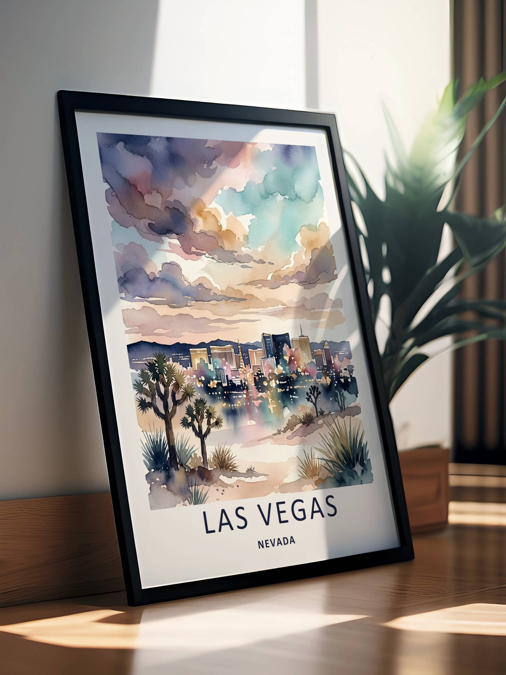Las Vegas watercolor skyline print displayed in a sleek black frame on a minimalist wall. The artwork features dreamy tones of indigo navy, teal, and dusty rose clouds over a detailed, glowing Nevada strip.