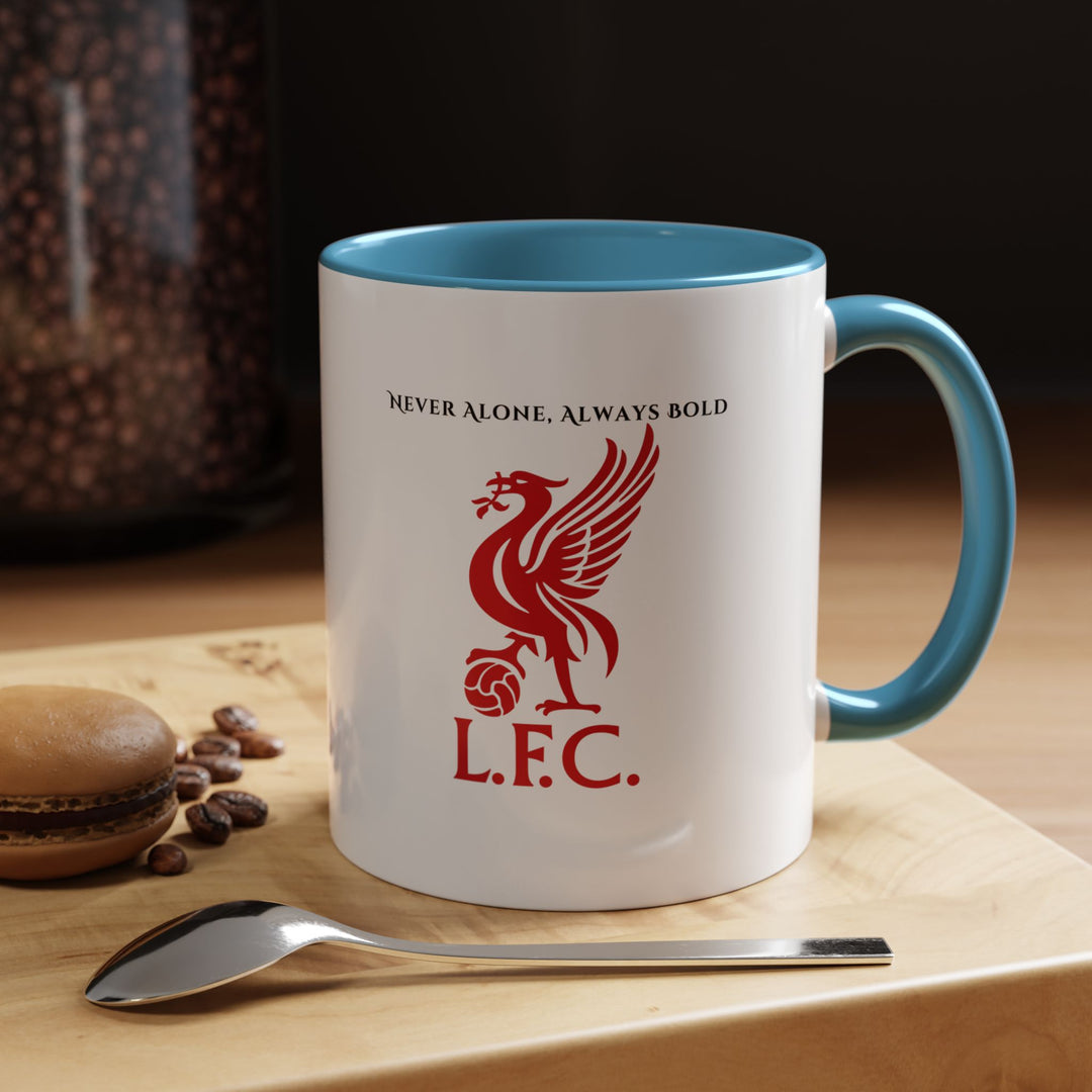 A blue Liverpool FC mug showcasing the official crest in high clarity, displayed in a relaxed workplace or home environment. The cool tone of the mug contrasts with the iconic emblem, making it a subtle yet meaningful way for supporters to show loyalty. Ideal for enjoying coffee, tea, or hot chocolate while staying connected to the club.