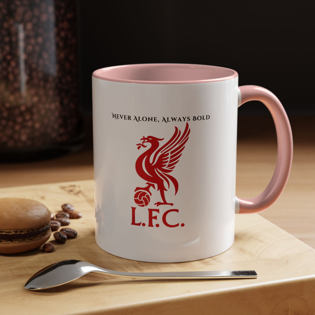 A pink Liverpool FC mug decorated with the official crest, captured with soft lighting to highlight its fun and expressive personality. Perfect for fans who love to blend personal style with team spirit, bringing warmth and joy to tea or coffee moments while celebrating the bond shared by Reds supporters worldwide.