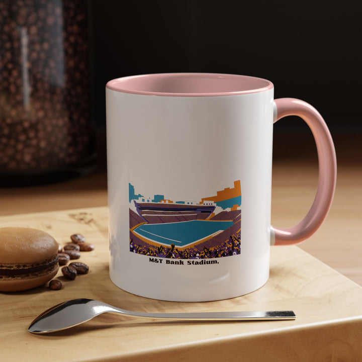 A pink M&T Bank Stadium ceramic mug featuring a detailed stadium illustration that stands out against the stylish pink tone. Designed for Baltimore Ravens supporters who prefer a modern and expressive aesthetic. Suitable for daily coffee, tea, or display in a fan-themed home or workplace setup.
