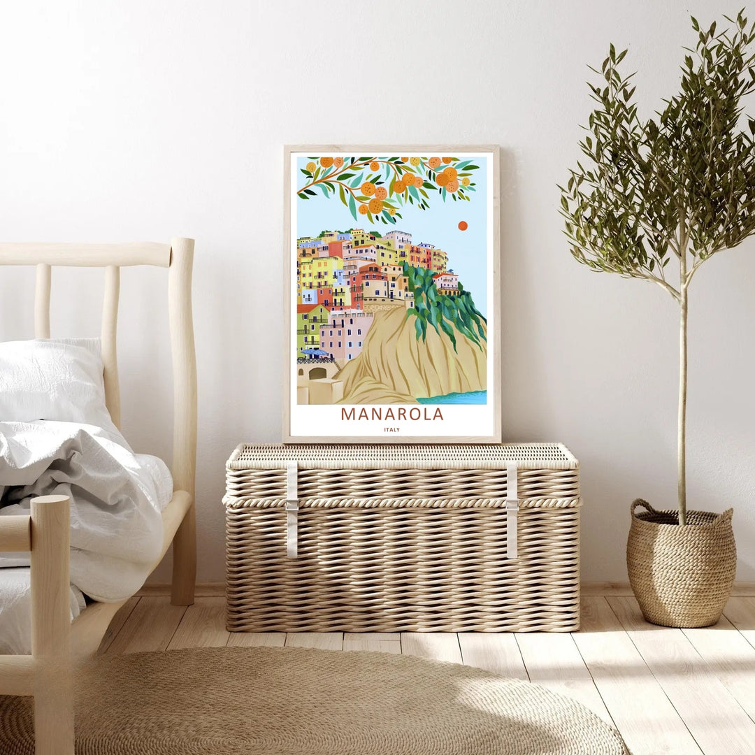 An elegant print style of the scenic Italian cliffs in Manarola Cinque Terre Italy framed by an orange citrus branch, offered as an unframed print, wrapped canvas, or premium retro black frame.