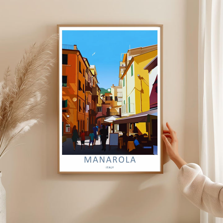 A bold graphic travel poster capturing the intimate ground-level perspective and vibrant street architecture of Manarola Cinque Terre Italy, ready to order as an unframed print or a natural wood frame.