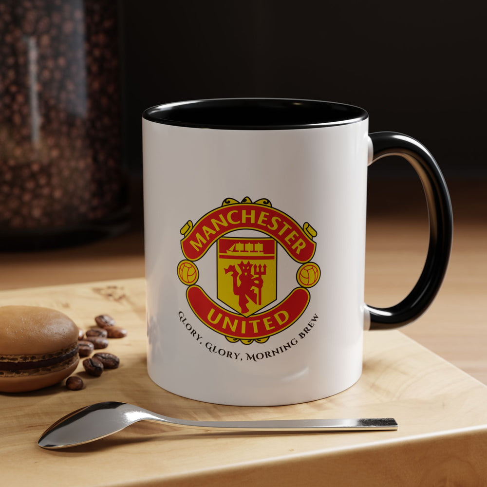 A sleek black Manchester United mug showcasing the official club crest. The bold black ceramic provides a modern aesthetic while highlighting the iconic Red Devils emblem. Perfect for coffee, tea, or hot chocolate at home, office, or for gifting to dedicated Manchester United fans, collectors, or football enthusiasts.