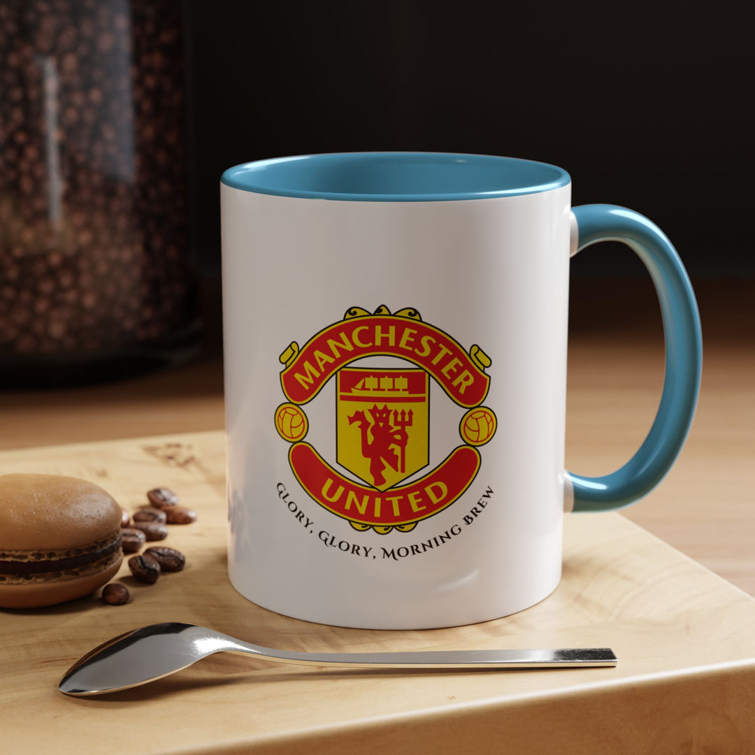 A blue Manchester United mug with the club’s official crest printed vividly on high-quality ceramic. Designed for Red Devils fans, it’s perfect for morning coffee, evening tea, or match-day beverages. The blue tone creates an attractive contrast that emphasizes the iconic logo, making it a collector’s-worthy piece of fan merchandise.