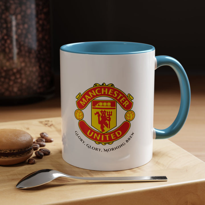 A blue Manchester United mug with the club’s official crest printed vividly on high-quality ceramic. Designed for Red Devils fans, it’s perfect for morning coffee, evening tea, or match-day beverages. The blue tone creates an attractive contrast that emphasizes the iconic logo, making it a collector’s-worthy piece of fan merchandise.