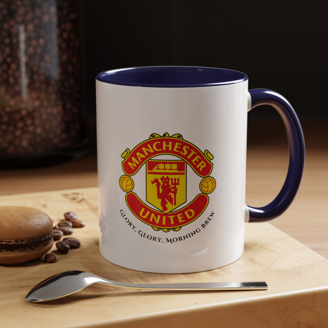 A navy blue Manchester United mug featuring the club crest in crisp, vivid detail. The deep navy tone gives a refined look while maintaining a fan-centered design. Ideal for daily coffee or tea, home, office, or match-day use, this mug celebrates the Red Devils’ history, energy, and identity with every sip.