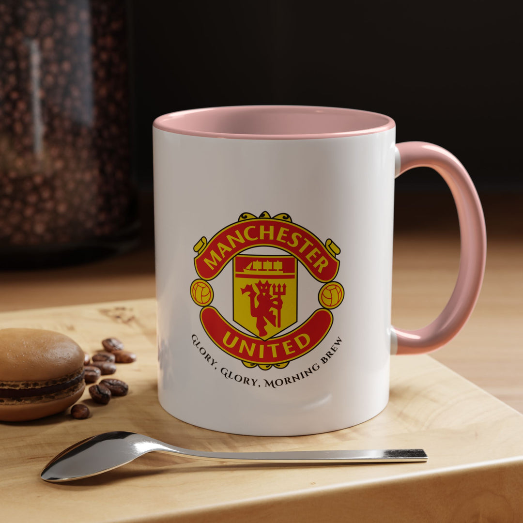 A pink Manchester United mug displaying the official club crest in bright, detailed colors. Ideal for supporters who want a playful yet stylish way to show Red Devils pride while enjoying coffee, tea, or hot drinks. Durable and comfortable, this pink mug makes a great gift or addition to any fan’s kitchen or office.