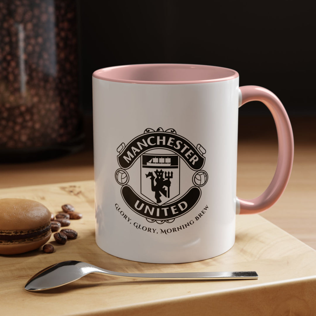 A pink Manchester United coffee mug featuring the official club crest on a stylish pink ceramic base. Designed for fans who enjoy a modern, playful look while showing their Red Devils pride. Suitable for coffee, tea, or hot drinks at home or at work, this mug combines everyday functionality with a unique supporter aesthetic.