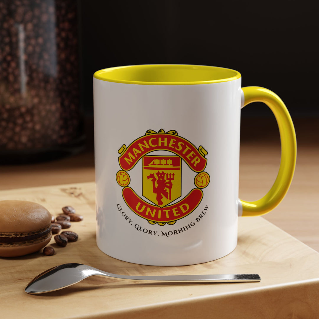 A yellow Manchester United ceramic mug with the official club crest printed on the front. The vibrant yellow color adds energy while celebrating Red Devils fandom. Perfect for coffee, tea, or hot chocolate at home, the office, or during game-day events, making it a memorable gift or collectible for Manchester United supporters.