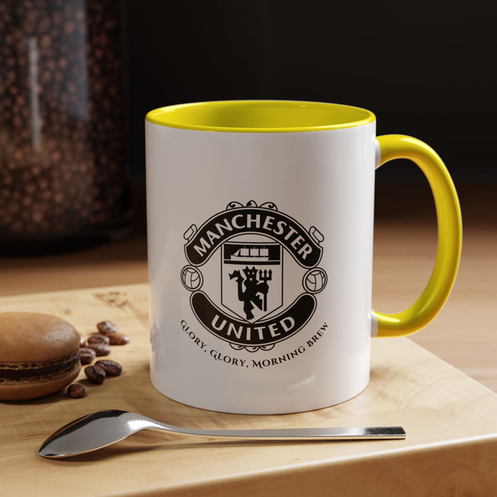 A yellow Manchester United coffee mug with the iconic club crest printed vividly. The cheerful yellow color emphasizes energy and enthusiasm for the Red Devils, making it a standout fan piece. Perfect for hot drinks, home, office, or match-day celebrations, and ideal as a gift for Manchester United supporters of all ages.