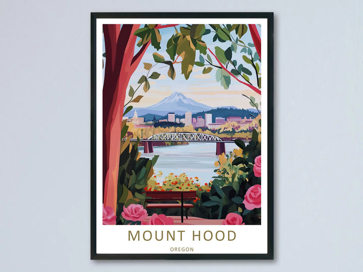 High-contrast graphic illustration of Mount Hood framed by pink roses and green leaves, shown in a modern black frame hanging on a neutral wall.