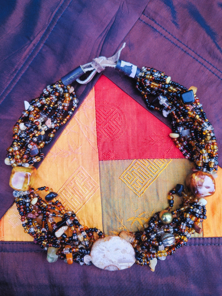 Handcrafted multi-strand earthy seed bead choker with large agate stone focal point.