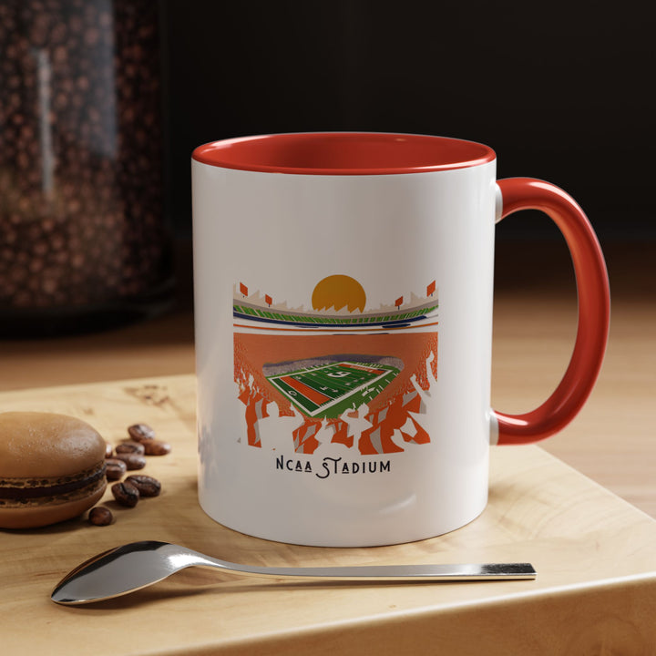 A red NCAA Stadium mug featuring a detailed artistic illustration of a college football stadium. The vibrant red color makes the mug stand out while celebrating college football pride. Perfect for morning coffee, afternoon tea, or hot chocolate, it’s ideal for home, office, tailgates, or as a collector’s item for college football fans.