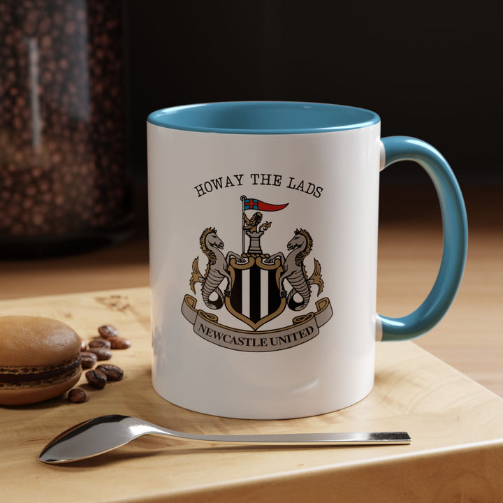 A blue Newcastle United coffee mug showcasing the official crest in clear, detailed print. The vibrant blue color contrasts beautifully with the emblem, highlighting Magpies pride. Ideal for coffee, tea, or hot drinks at home, office, or tailgates, this ceramic mug combines practicality with fan enthusiasm.