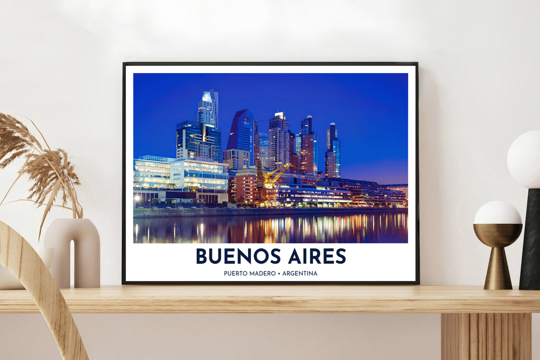 High above the harbor docks of Buenos Aires at dusk, a striking Puerto Madero poster displays glowing high-rises, historic yellow cranes, and golden window reflections, proudly presented by MapYourDreams across fine art paper, solid wood frames, and stretched canvas options.