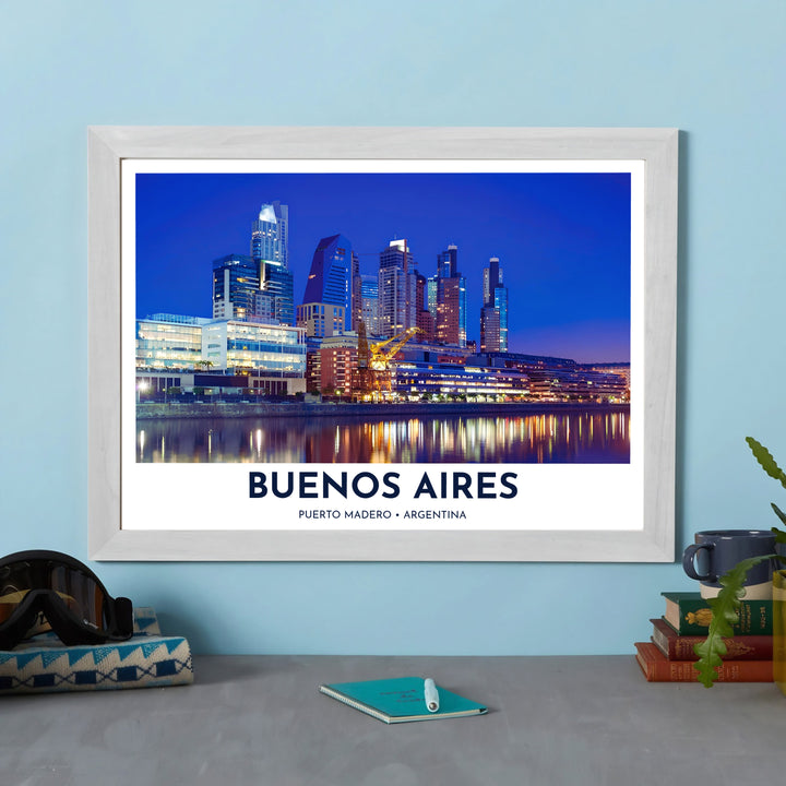 Rendered in crisp fine art nighttime photography detail, this Puerto Madero wall art depicts modern glass high-rises and historic dockyard cranes reflecting on the water, designed by MapYourDreams in unframed, custom framed, and canvas finishes.