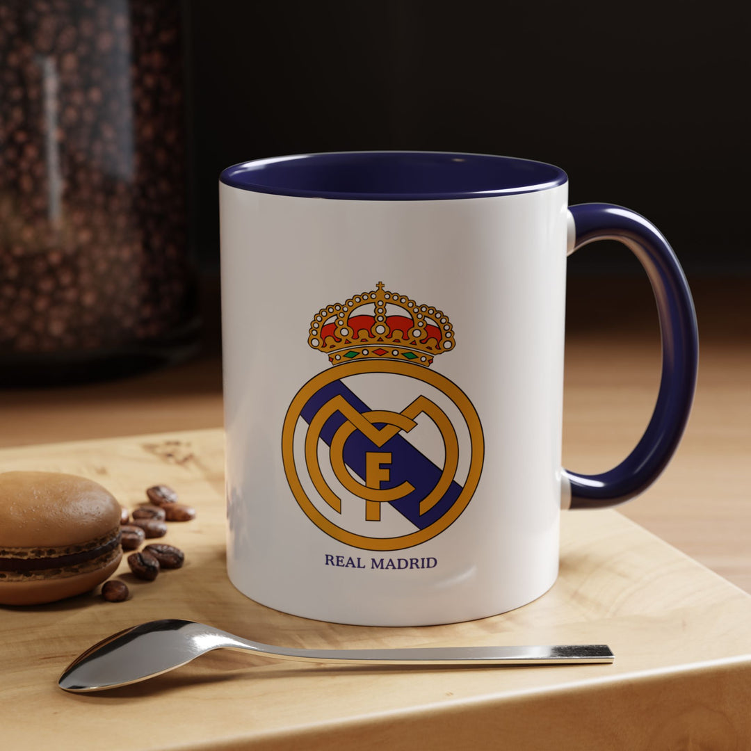 This ceramic mug showcases the official Real Madrid logo and is perfect for coffee, tea, or hot drinks. The navy blue color provides a refined and classic look, making it ideal for collectors, office use, or fans who prefer a more understated way to display loyalty to Los Blancos.