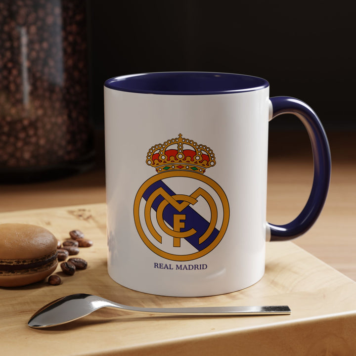 This ceramic mug showcases the official Real Madrid logo and is perfect for coffee, tea, or hot drinks. The navy blue color provides a refined and classic look, making it ideal for collectors, office use, or fans who prefer a more understated way to display loyalty to Los Blancos.
