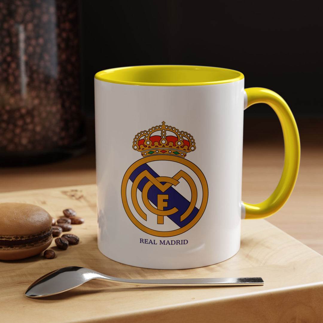 Show your support for Real Madrid with this ceramic mug featuring the club logo. Ideal for coffee, tea, or hot chocolate, it brings vibrant energy to daily routines or match-day celebrations. The sunny yellow color makes it a standout piece in any fan’s collection or gift display.