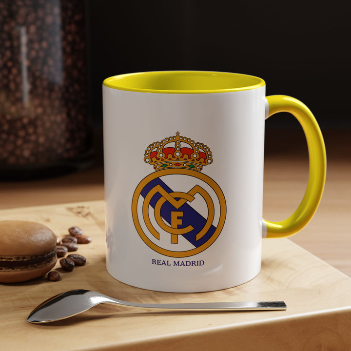 Show your support for Real Madrid with this ceramic mug featuring the club logo. Ideal for coffee, tea, or hot chocolate, it brings vibrant energy to daily routines or match-day celebrations. The sunny yellow color makes it a standout piece in any fan’s collection or gift display.