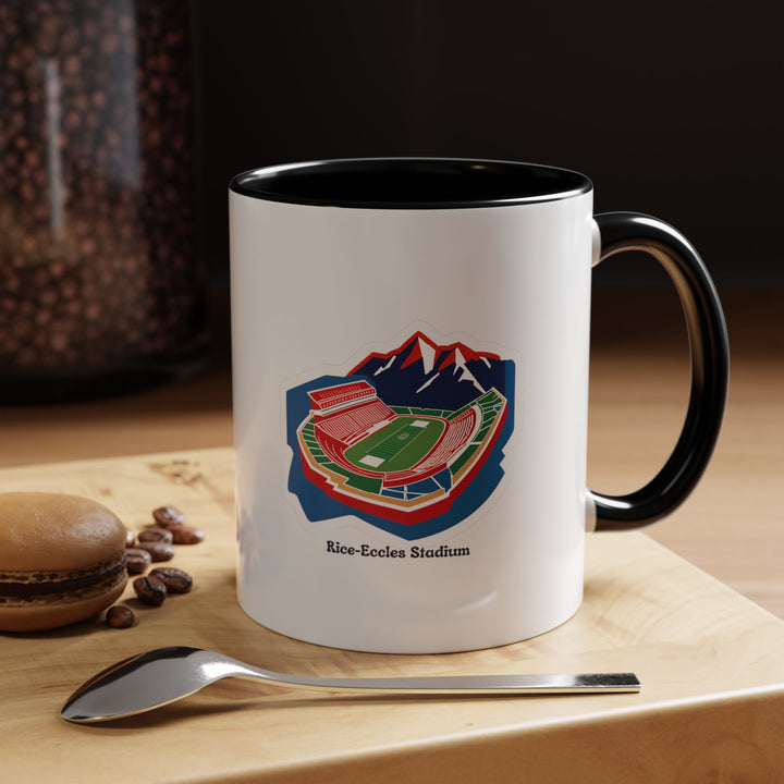 A black Rice-Eccles Stadium mug with a detailed stadium illustration. The sleek black ceramic creates a modern, elegant aesthetic while showcasing Utah Utes pride. Ideal for coffee, tea, or hot beverages at home, office, or game-day celebrations, making it a collectible for fans.