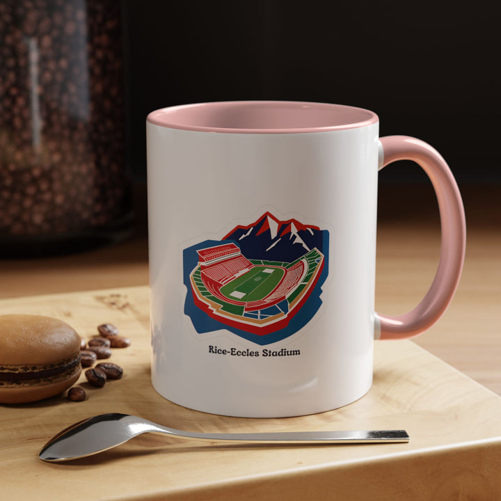 A pink Rice-Eccles Stadium mug featuring the University of Utah football stadium in detailed print. The playful pink color adds a modern twist to fan merchandise, ideal for coffee, tea, or hot chocolate. Perfect for home, office, or game-day displays for Utah Utes supporters.