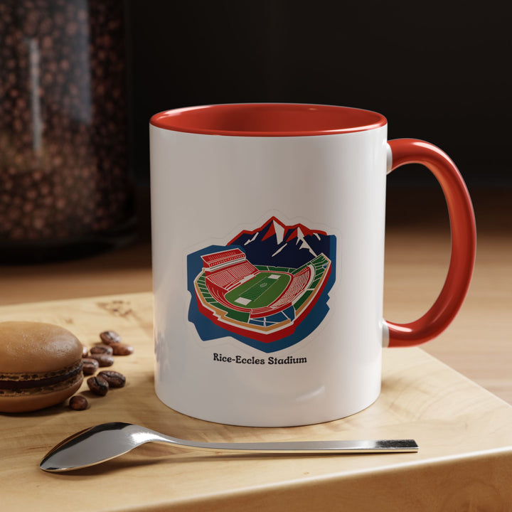 A red Rice-Eccles Stadium mug featuring a detailed illustration of the University of Utah’s iconic football stadium. Perfect for coffee, tea, or hot chocolate, the vibrant red color reflects Utes pride while adding energy to daily routines. Ideal for home, office, or tailgates, this ceramic mug is a functional collectible for fans.