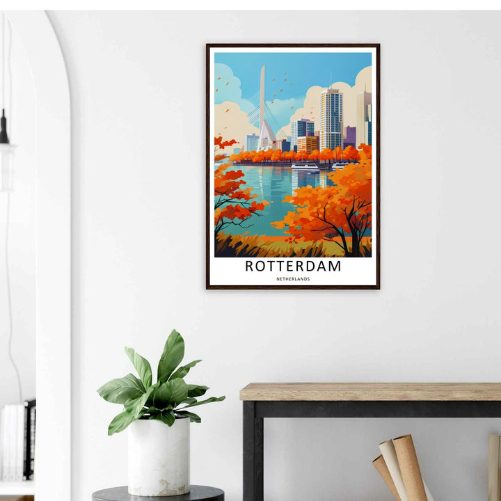 A Rotterdam poster autumn skyline print showing bright orange trees along a riverfront with the Erasmus Bridge. This European wall art is sold framed or as a canvas by MapYourDreams.