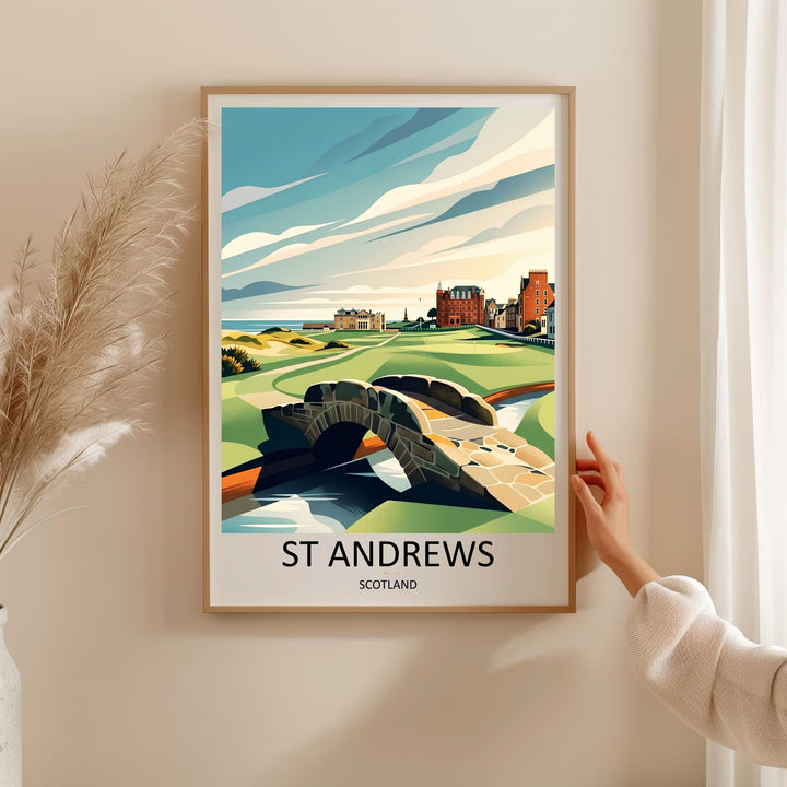 Contemporary travel poster art of St Andrews Links golf course, featuring detailed green fairways and sand dunes framing the iconic Swilcan stone bridge, with historic coastal buildings and the sea visible on a bright, scenic day.