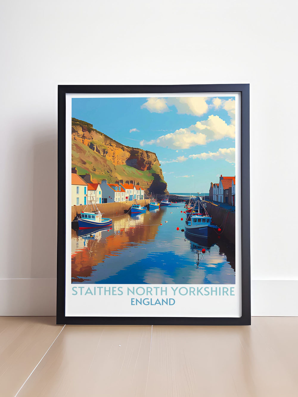 Staithes North Yorkshire wall art depicting the serene harbor surrounded by rugged cliffs and vibrant fishing boats. Ideal for lovers of seaside vistas and nautical themes.