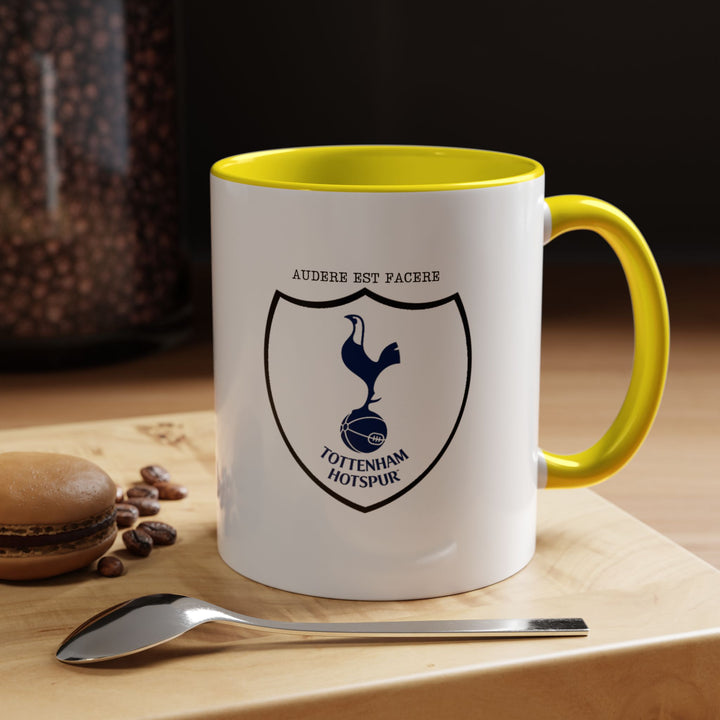 A yellow Tottenham Hotspur mug displaying the official club crest in sharp detail. The bright yellow color adds cheer and energy, emphasizing Spurs pride. Perfect for coffee, tea, or hot drinks at home, office, or match-day events, making it a vibrant collectible for fans.