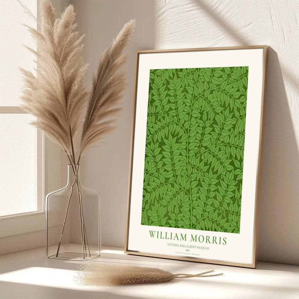 High quality William Morris Ash green botanical leaf print displaying dense foliage patterns and rich forest tones perfect for refreshing living room wall decor.