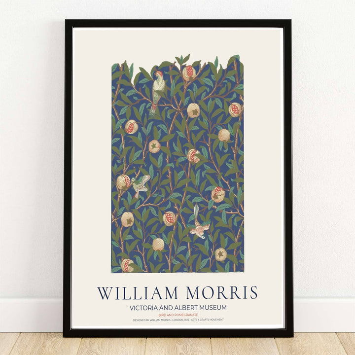 High quality William Morris Bird and Pomegranate navy floral print displaying delicate perching birds, ripe fruit, and dense leaves perfect for dark academia living room wall decor.