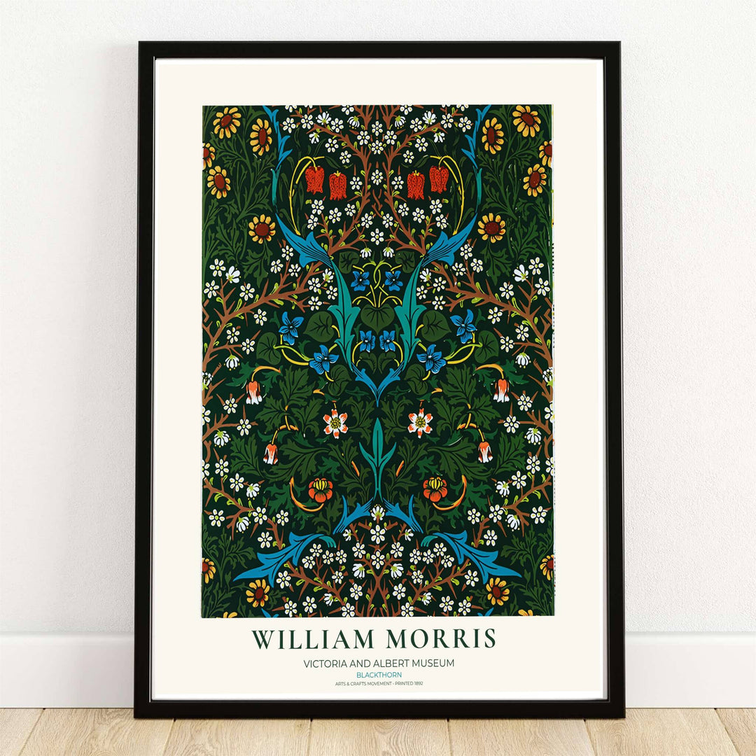 High quality William Morris Blackthorn dark green floral print displaying delicate white blossoms, blue wildflowers, and dense branches perfect for dark academia living room wall decor.