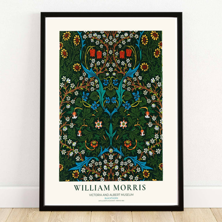 High quality William Morris Blackthorn dark green floral print displaying delicate white blossoms, blue wildflowers, and dense branches perfect for dark academia living room wall decor.