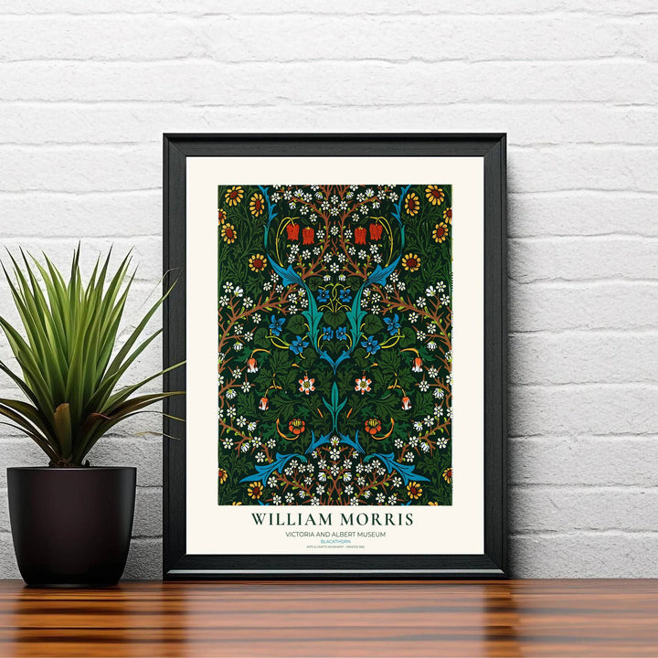 Modern decorative floral print of William Morris Blackthorn featuring detailed flowering branches and dense dark green leaf patterns, ideal for contemporary wall decoration and dramatic living areas.