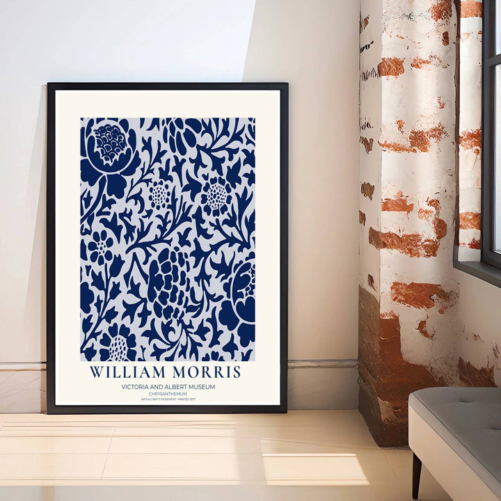 Decorative wall art print of William Morris Chrysanthemum navy and white poster set against a clean cream margin, bringing timeless vintage British botanical elegance into home interior spaces.