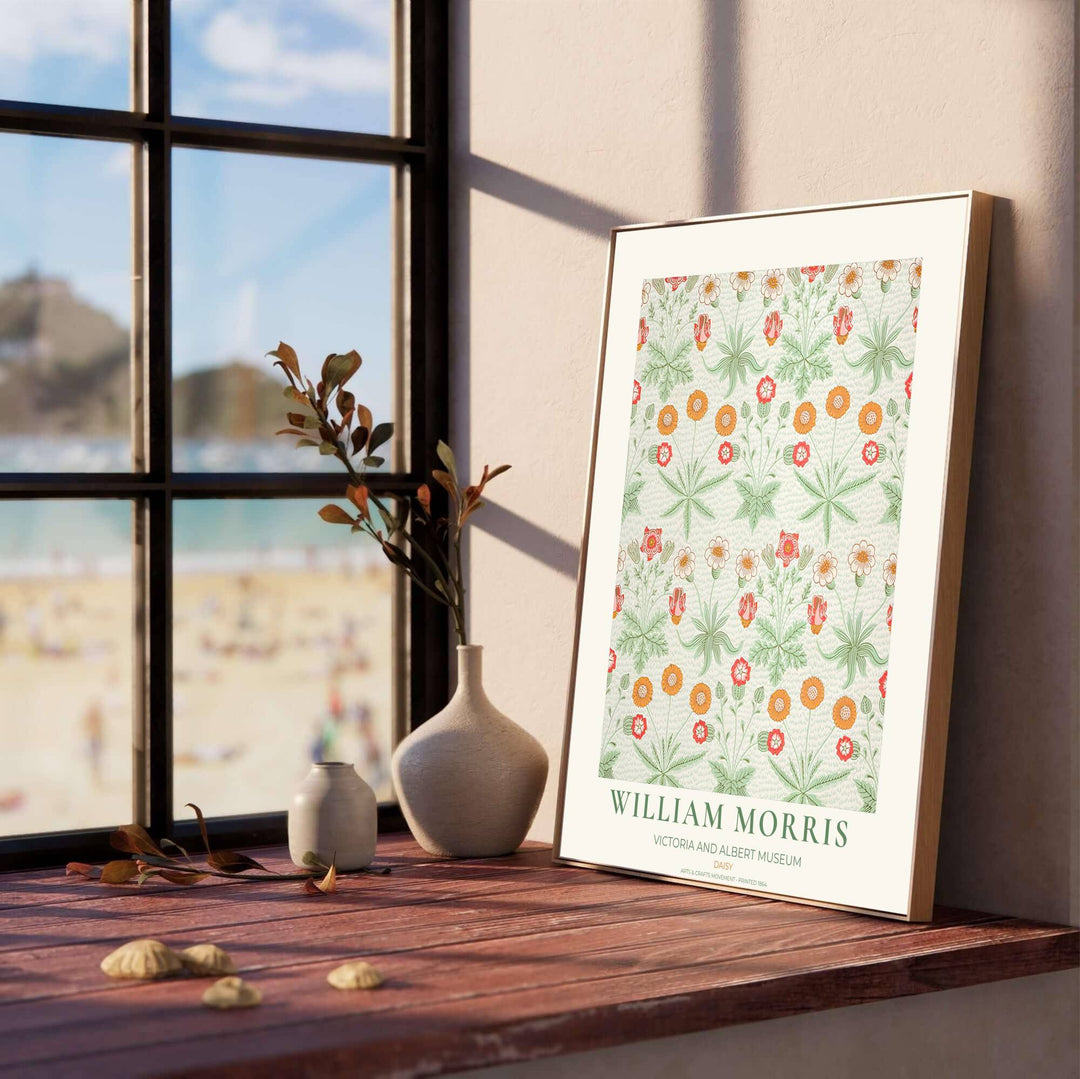 Decorative wall art print of William Morris Daisy green and orange poster set against a clean cream margin, bringing timeless vintage British botanical elegance into home interior spaces.