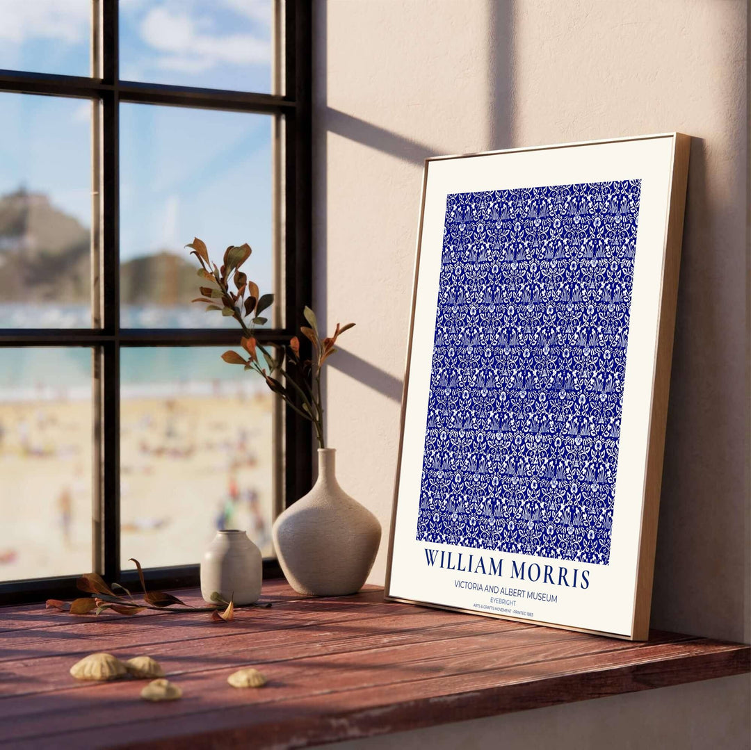 Decorative wall art print of William Morris Eyebright blue and white poster set against a clean cream margin, bringing timeless vintage British botanical elegance into home interior spaces.
