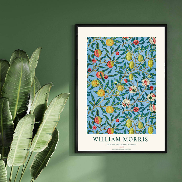 Close-up view of stylized citrus fruits, detailed leaves, and red floral accents from the famous William Morris Fruit poster designed in 1862.