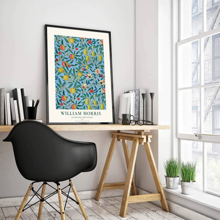 Symmetrical arrangement of hanging lemons, peaches, and pomegranates rendered in warm yellow, coral pink, and deep green over a soft blue field.
