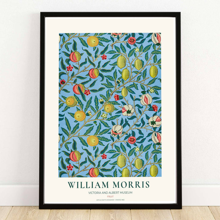 High quality William Morris Fruit blue lemon print displaying ripe yellow citrus, pomegranates, and olive leaves perfect for bright kitchen wall decor.
