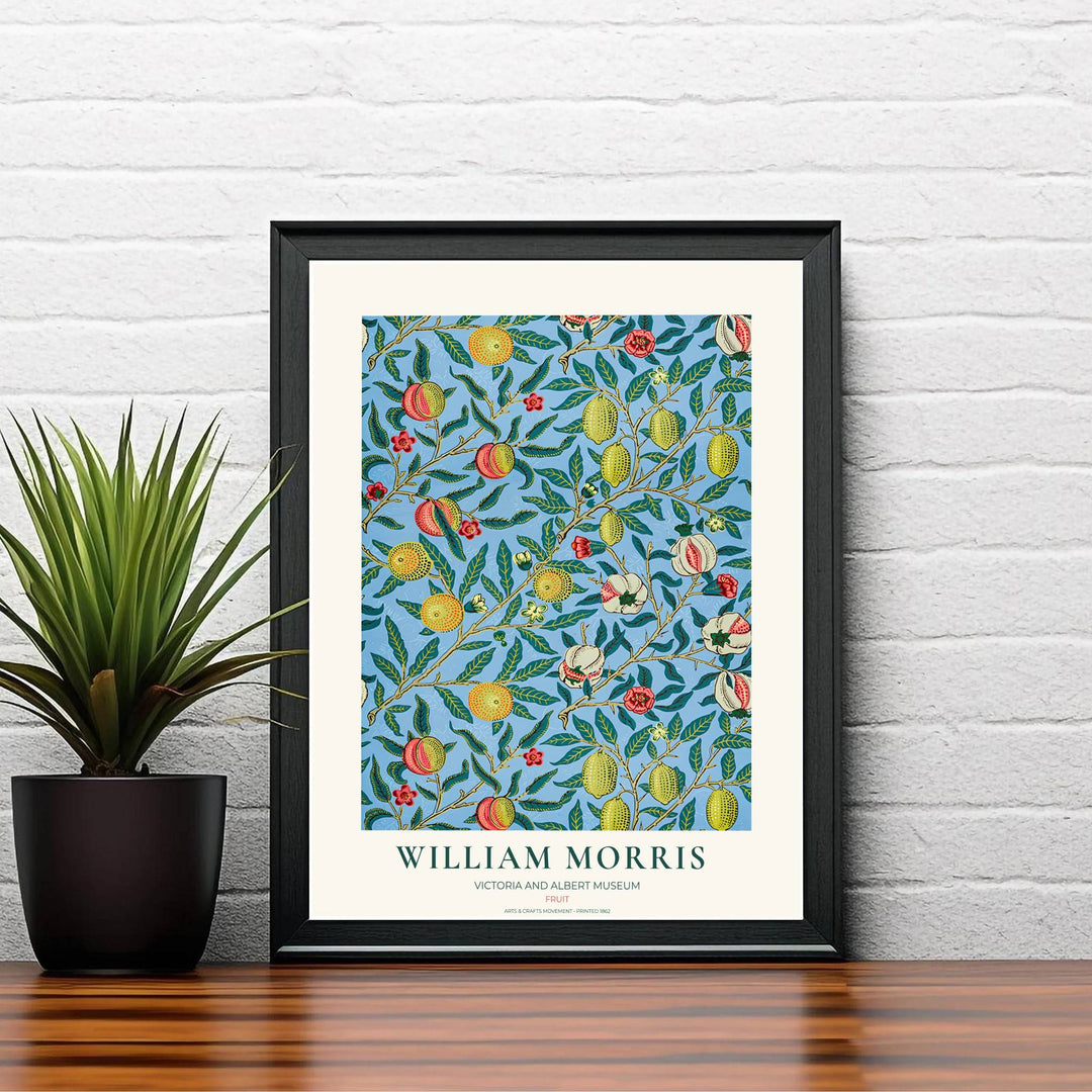 Delicate olive green leaves intertwined with yellow citrus and coral-red fruits in a restored vintage William Morris exhibition print for home gallery walls.