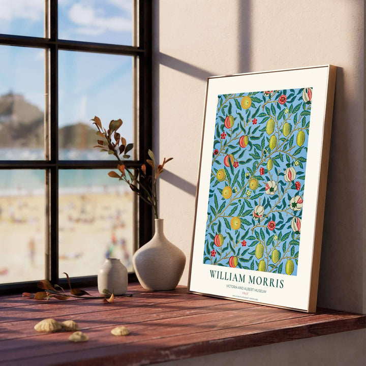 Historic Arts and Crafts Movement wall art print displaying the iconic Pomegranate pattern with rich botanical details and museum typography inside a cream border.